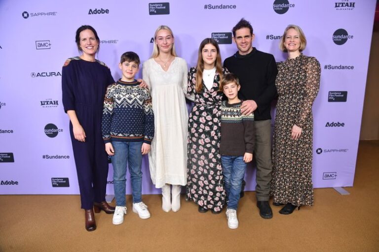 Family etc in front of sponsor board